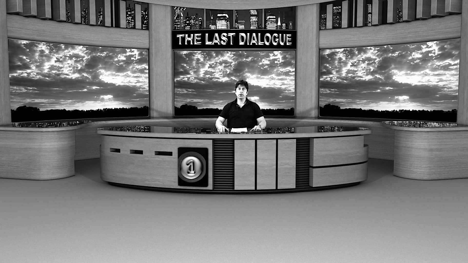 a greyscale image of a man behind a desk