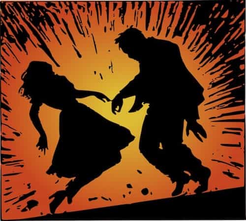 a silhouette of a man and a woman inside an explosion