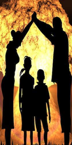 a silhouette of a family with background of fire and explosions